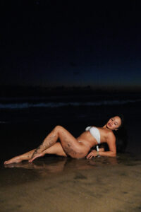 Emily Mai on a beach in Bali at night. 